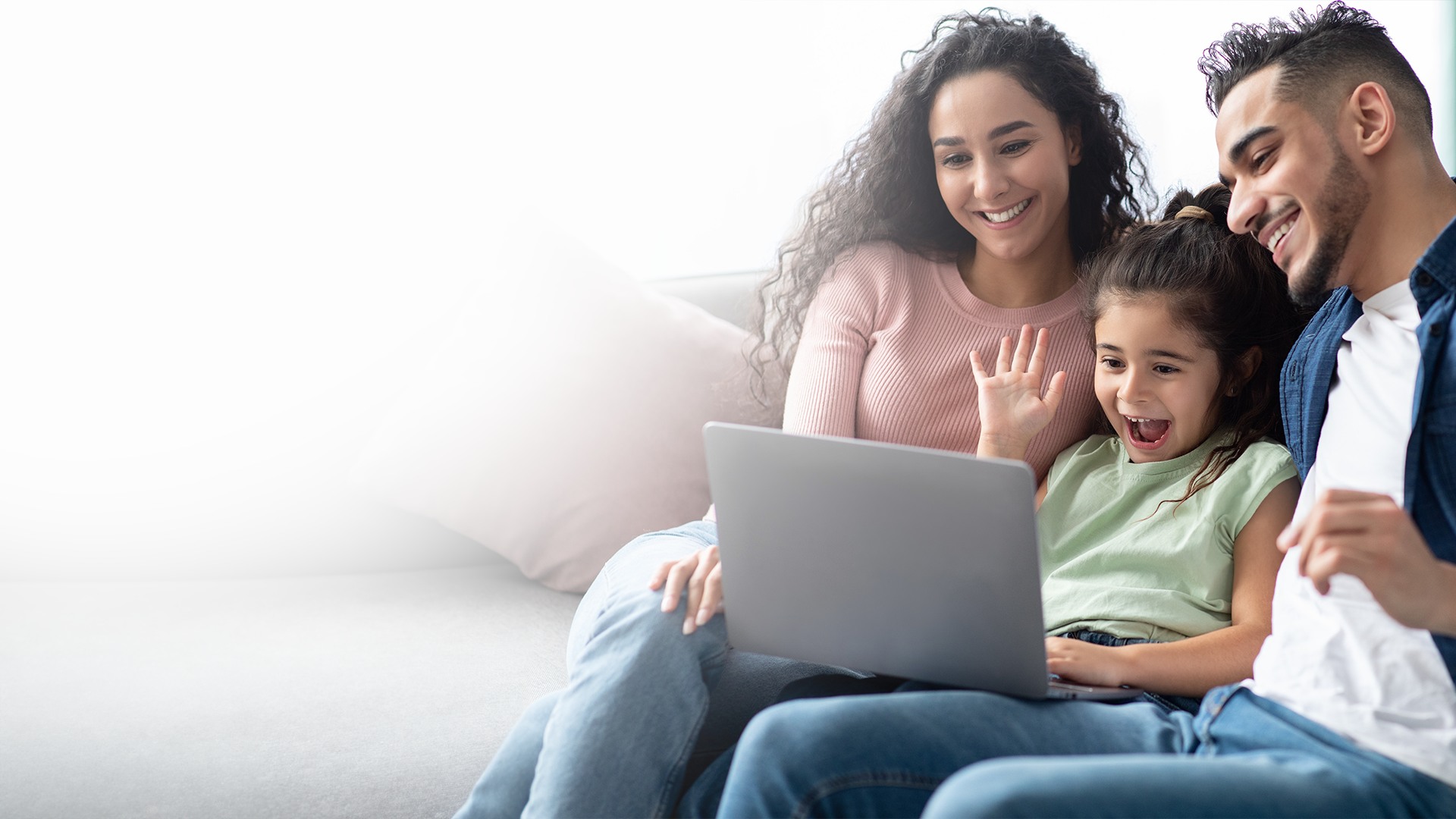 A smiling family with a laptop