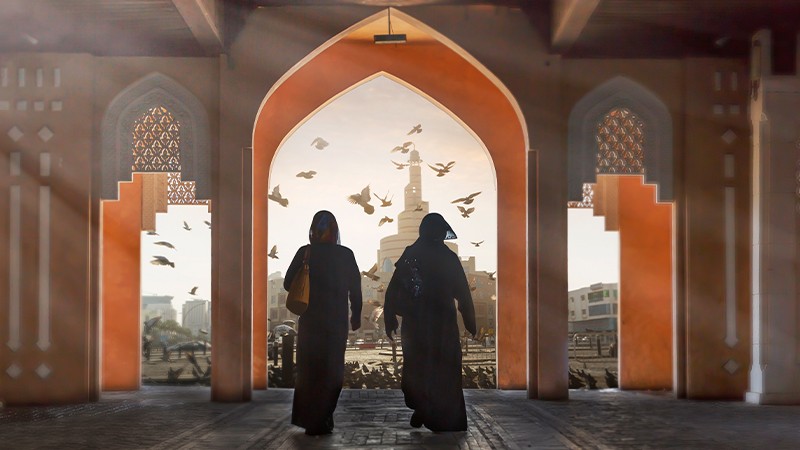 Two Muslim women coming out of a beautiful building