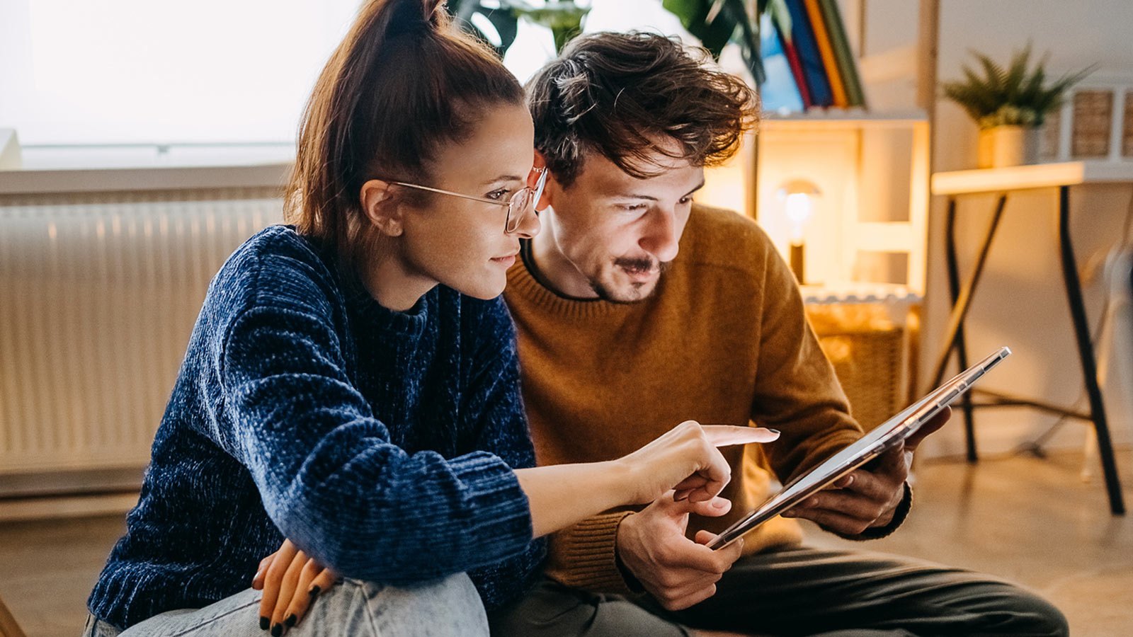 Man and woman with a tablet studying Visa Stay Secure