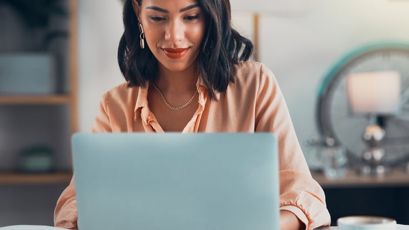 A woman reading the news on her laptop