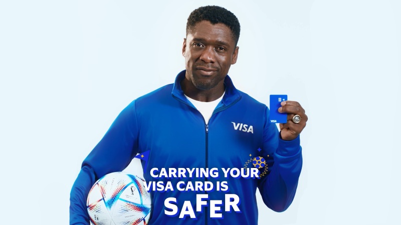 Clarence Seedorf holding a football and a Visa card
