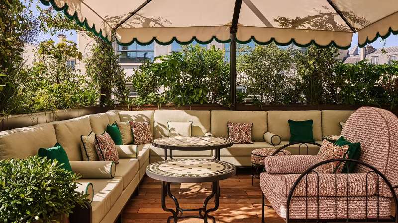Cozy outdoor terrace lounge with cushioned seating and lush greenery
