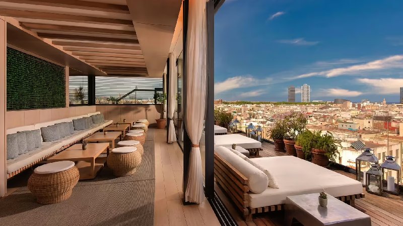 Elegant rooftop lounge with cushioned seating and panoramic city views