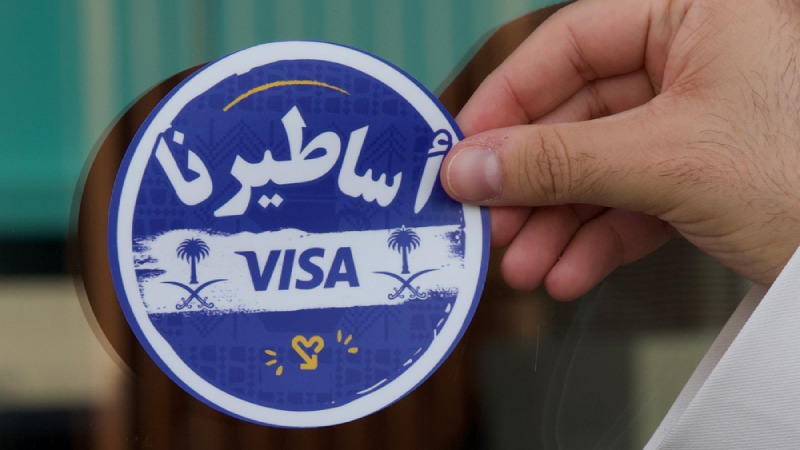 Visa sticker being applied