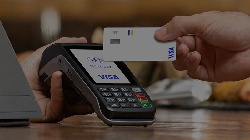 Payment by POS terminal with tap to pay and Visa card
